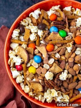 large orange bowl with caramel apple trail mix