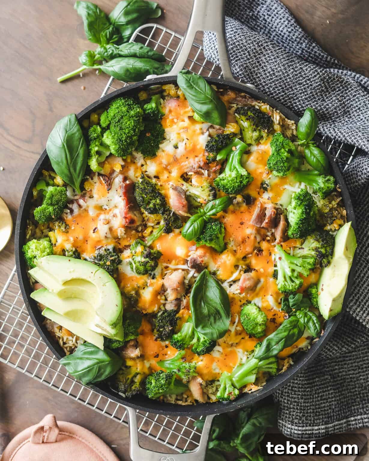 Chicken, Broccoli & Rice Casserole with Cheesy Sauce 2 Easy Chicken Broccoli and Cheese Casserole on a cooling rack with a dish cloth