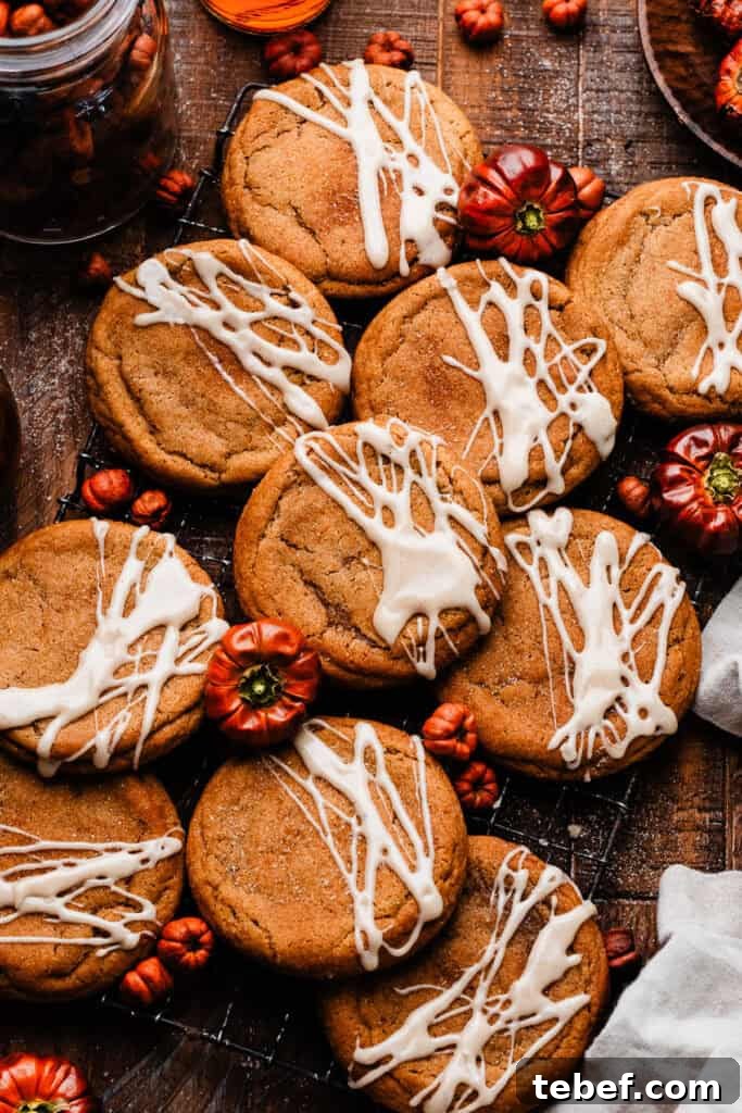 Chewy Pumpkin Cookies with Maple Glaze Recipe 13 Glazed pumpkin cookies on a wooden surface.