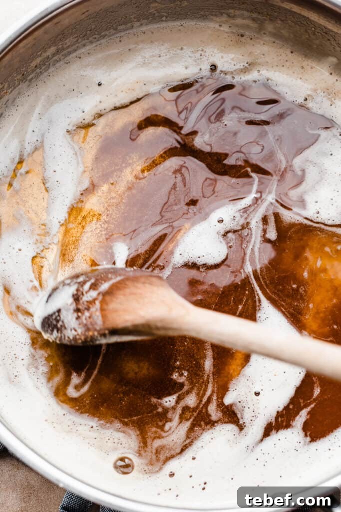 Chewy Pumpkin Cookies with Maple Glaze Recipe 4 A pan of brown butter being stirred.