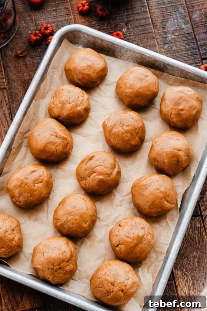 Chewy Pumpkin Cookies with Maple Glaze Recipe 7 Cookie dough balls scooped and lined up in rows on a baking sheet.