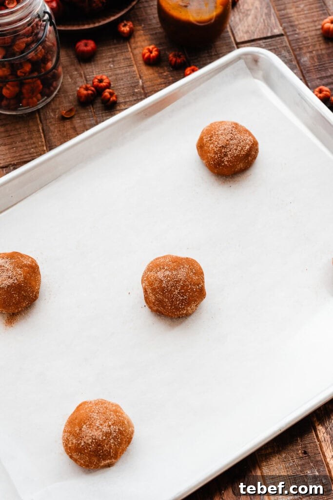 Chewy Pumpkin Cookies with Maple Glaze Recipe 8 Cookie dough balls spread out on a pan, ready for the oven.