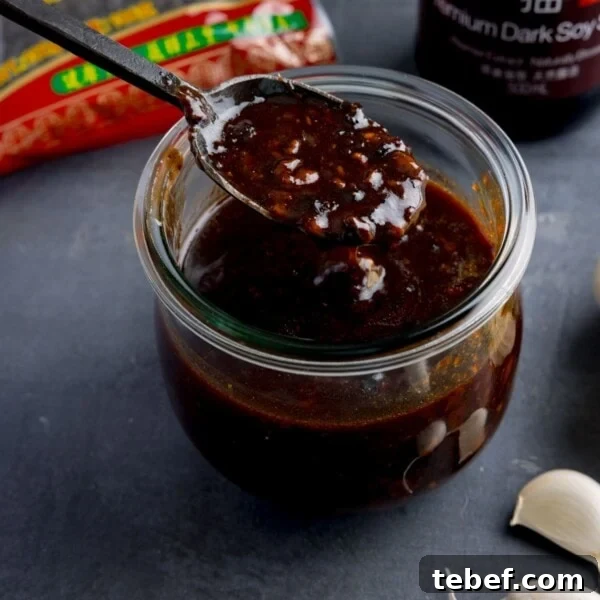 Creamy Beer Cheese Dip Recipe for Game Day and Parties 11 Jar filled with homemade black bean sauce with spoon.