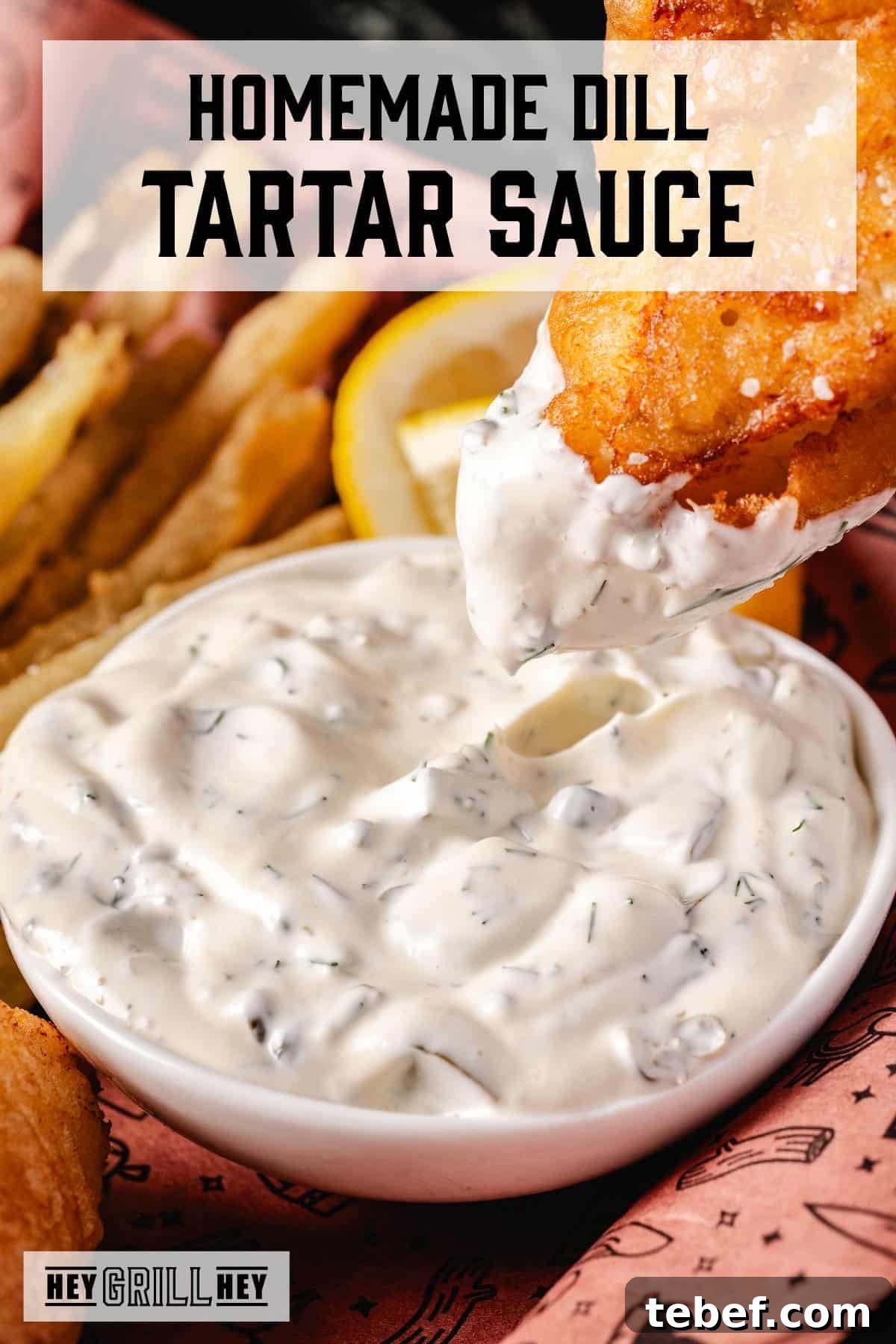 Creamy Dill Tartar Sauce Recipe for Seafood & Sandwiches 2 A white bowl full of tartar sauce with fried fish being dipped in it. The text overlay reads 'Homemade Dill Tartar Sauce' at the top, and 'Hey Grill Hey' at the bottom.