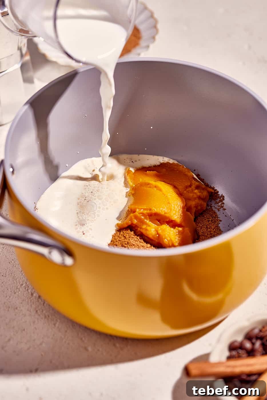 Iced Pumpkin Spice Latte Recipe: Creamy Fall Coffee at Home 5 cream, pumpkin and brown sugar in saucepan