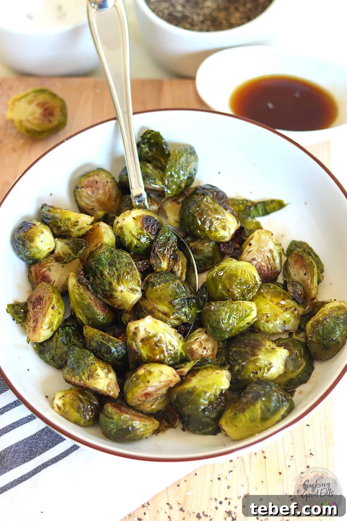 Maple Balsamic Glazed Brussels Sprouts — Air Fryer or Oven 2 A round white bowl of roasted brussels sprouts glazed with maple syrup and balsamic vinegar.