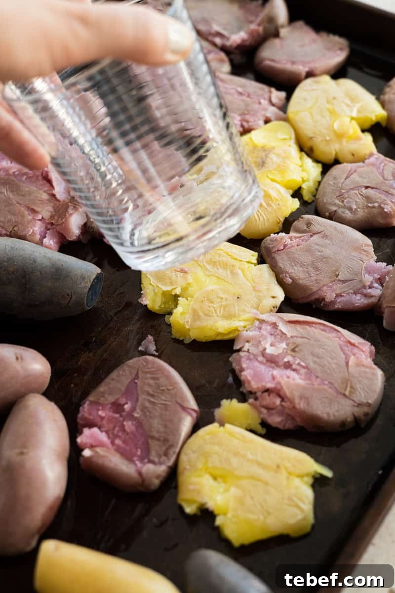 Garlic Rosemary Smashed Fingerling Potatoes Recipe 7 Using the bottom of a glass to smash the potatoes.