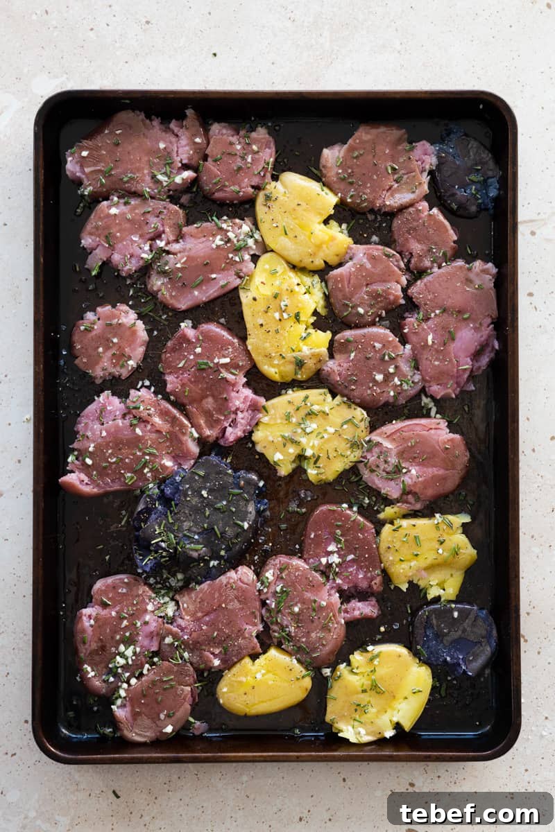 Garlic Rosemary Smashed Fingerling Potatoes Recipe 9 Smashed potatoes on a baking sheet ready to bake.