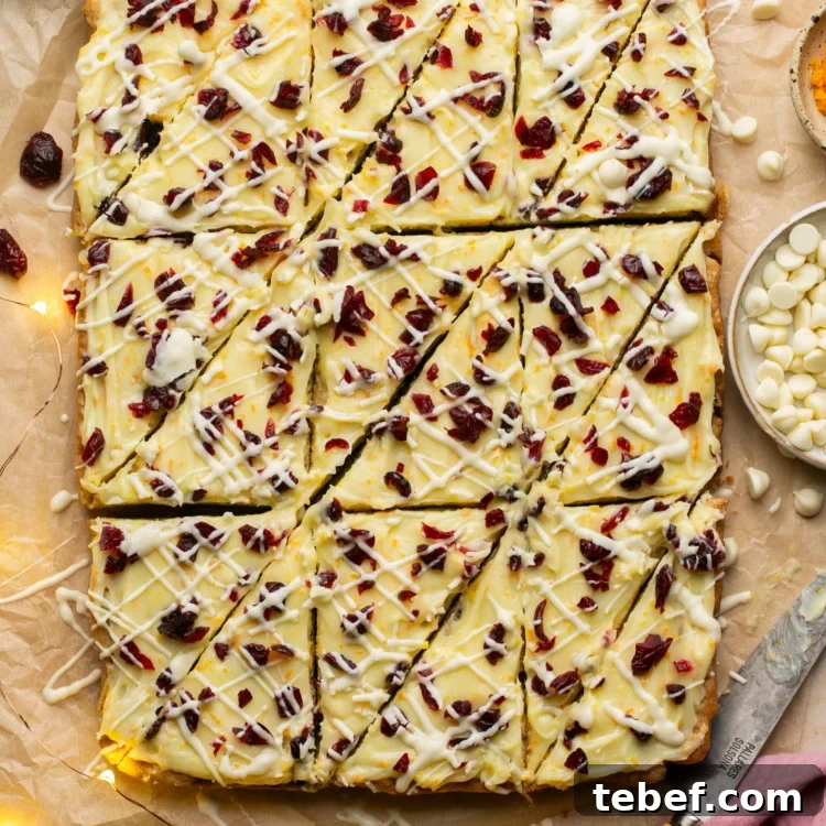sheet of cranberry bliss bars with triangleur cuts made