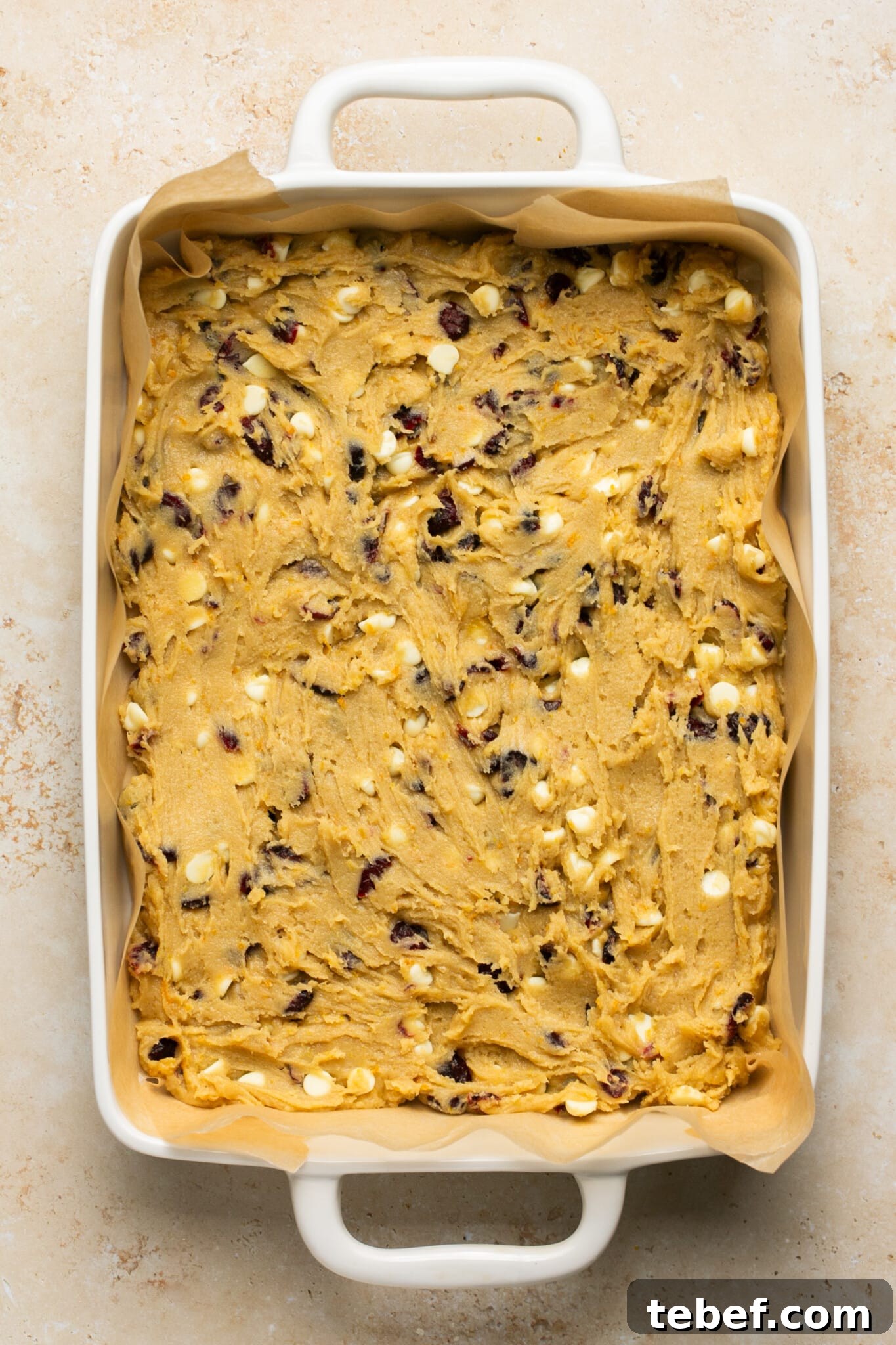 cranberry bliss bar batter spread evenly in a 9x13 white baking dish. 