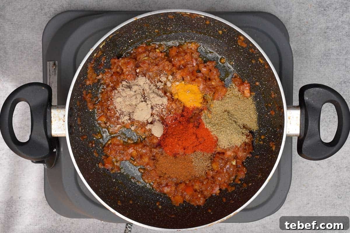 Punjabi Rajma Masala Recipe: Classic Spiced Kidney Beans 9 Dry spice powders added to the pan.