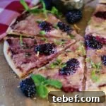 A subtly sweet fruit pizza made with blackberry jam, blackberries and marscapone cheese