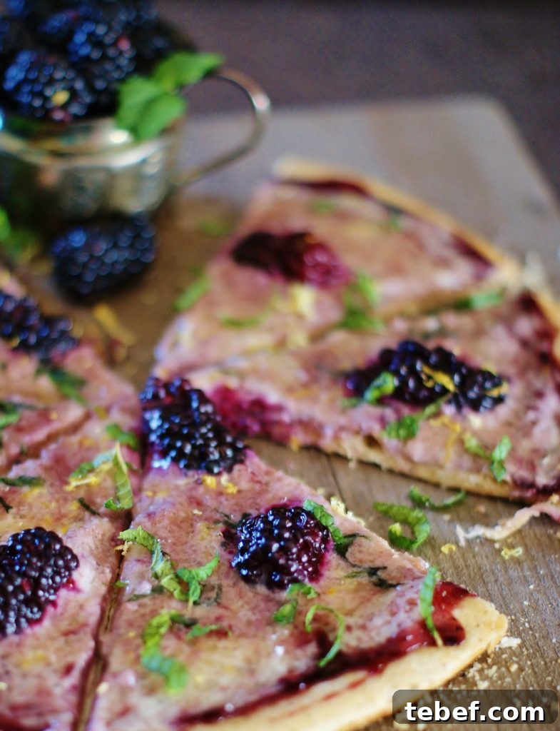 This blackberry mint pizza with subtly sweet marscapone cheese, plump blackberries, and blackberry jam is perfect for brunch, a savory dessert, coffee or tea time. A gorgeous mix of bread, cheese, fruit, and herbs, this pizza has all the ingredients of a romantic picnic without the picnic basket!
