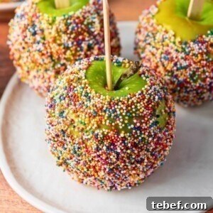 How to Make Classic Caramel Apples at Home in 5 Steps 15 Green apples dipped in a coating and rolled in colorful sprinkles.