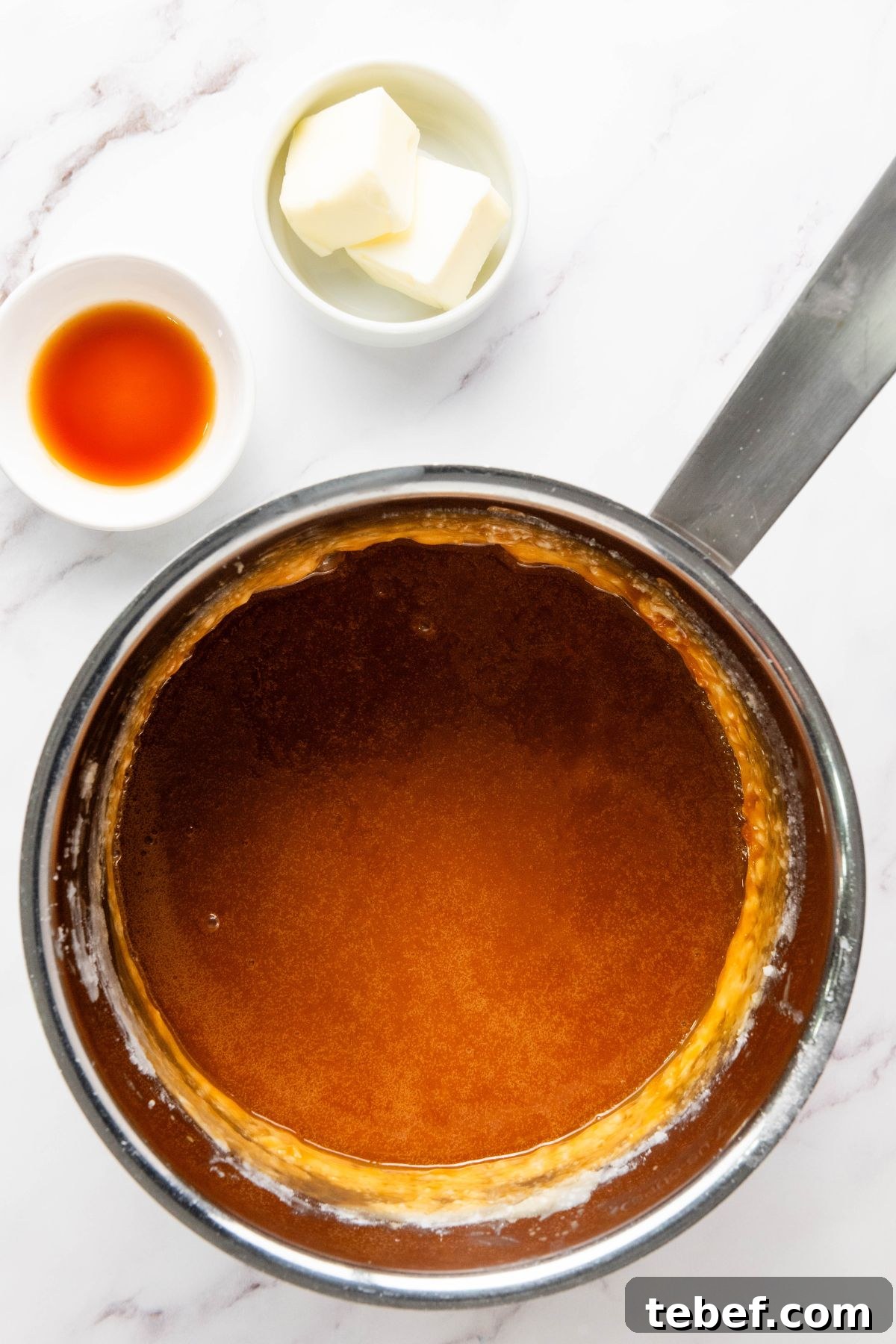 How to Make Classic Caramel Apples at Home in 5 Steps 5 Sugar being heated until it turns to an amber color in a saucepan.