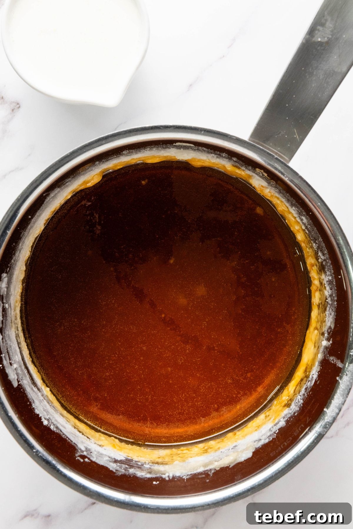 How to Make Classic Caramel Apples at Home in 5 Steps 6 Melted sugar with butter and vanilla added, in a large saucepan.
