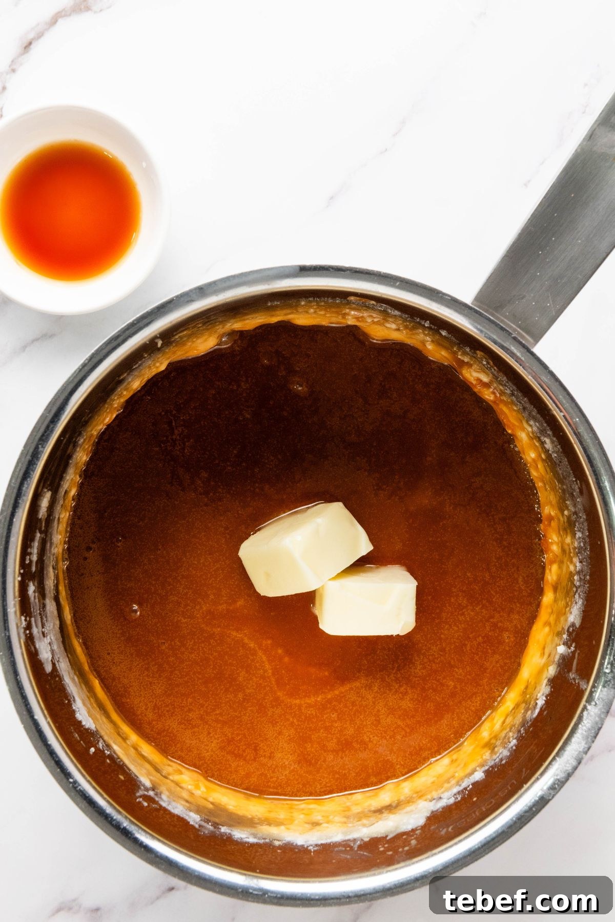How to Make Classic Caramel Apples at Home in 5 Steps 7 Large saucepan with butter being added.