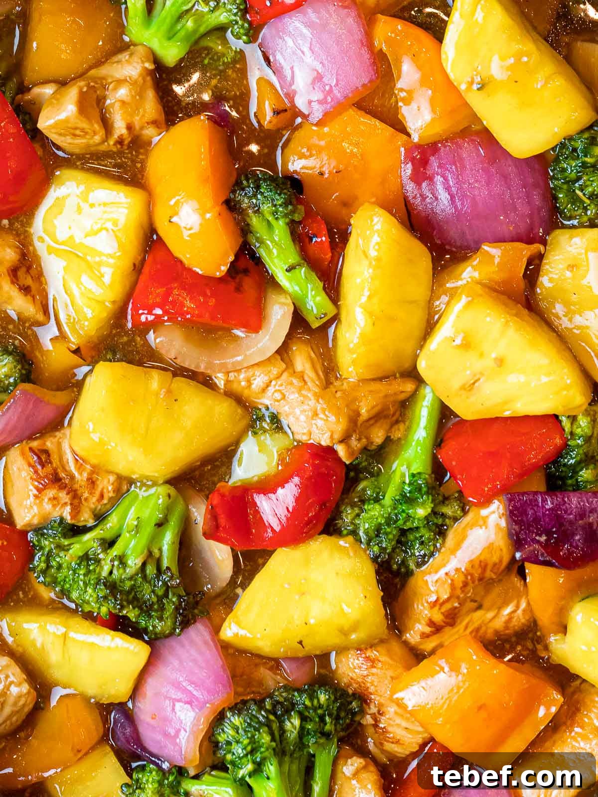 summer pineapple chicken stir fry with vegetables in a sweet and tangy sauce