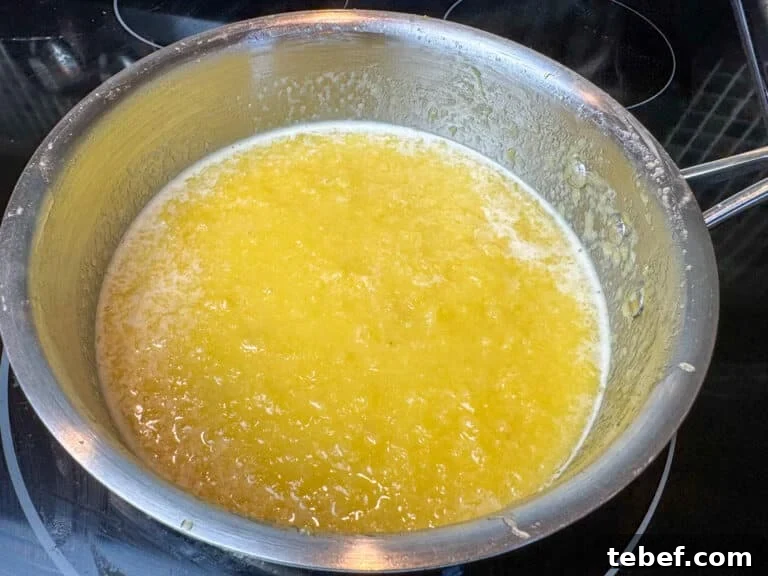 Classic Pineapple Icing Recipe for Cakes and Cupcakes 2 Sauce pan heating on a stove to make old fashioned boiled pineapple icing.