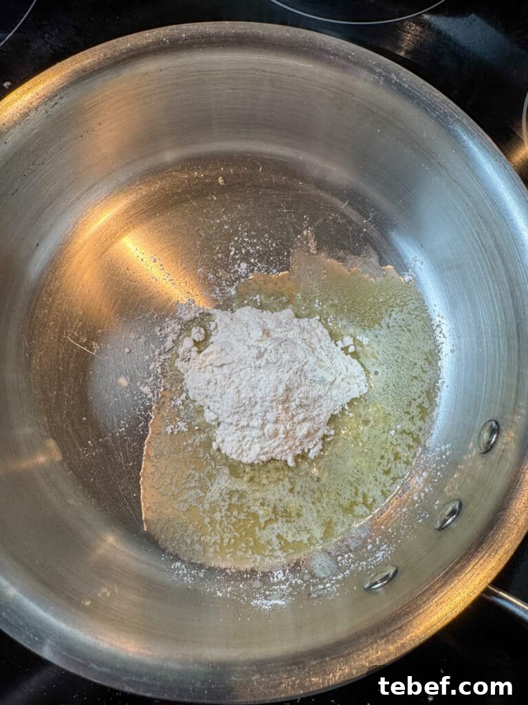 Classic Pineapple Icing Recipe for Cakes and Cupcakes 5 Flour poured on in a sauce pan on top of melted butter.