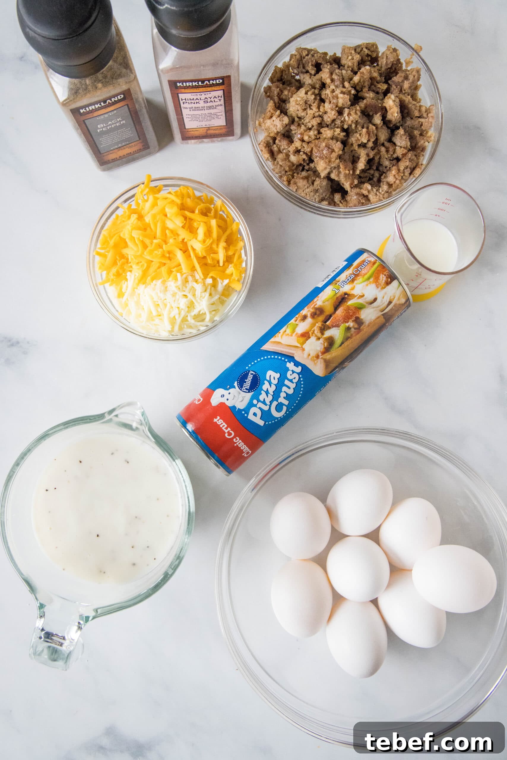 This satisfying breakfast pizza combines all of your breakfast favorites on top of a crispy pizza crust. It's so easy, baked in a sheet pan! Ingredients for a sausage, egg, and cheese breakfast pizza.