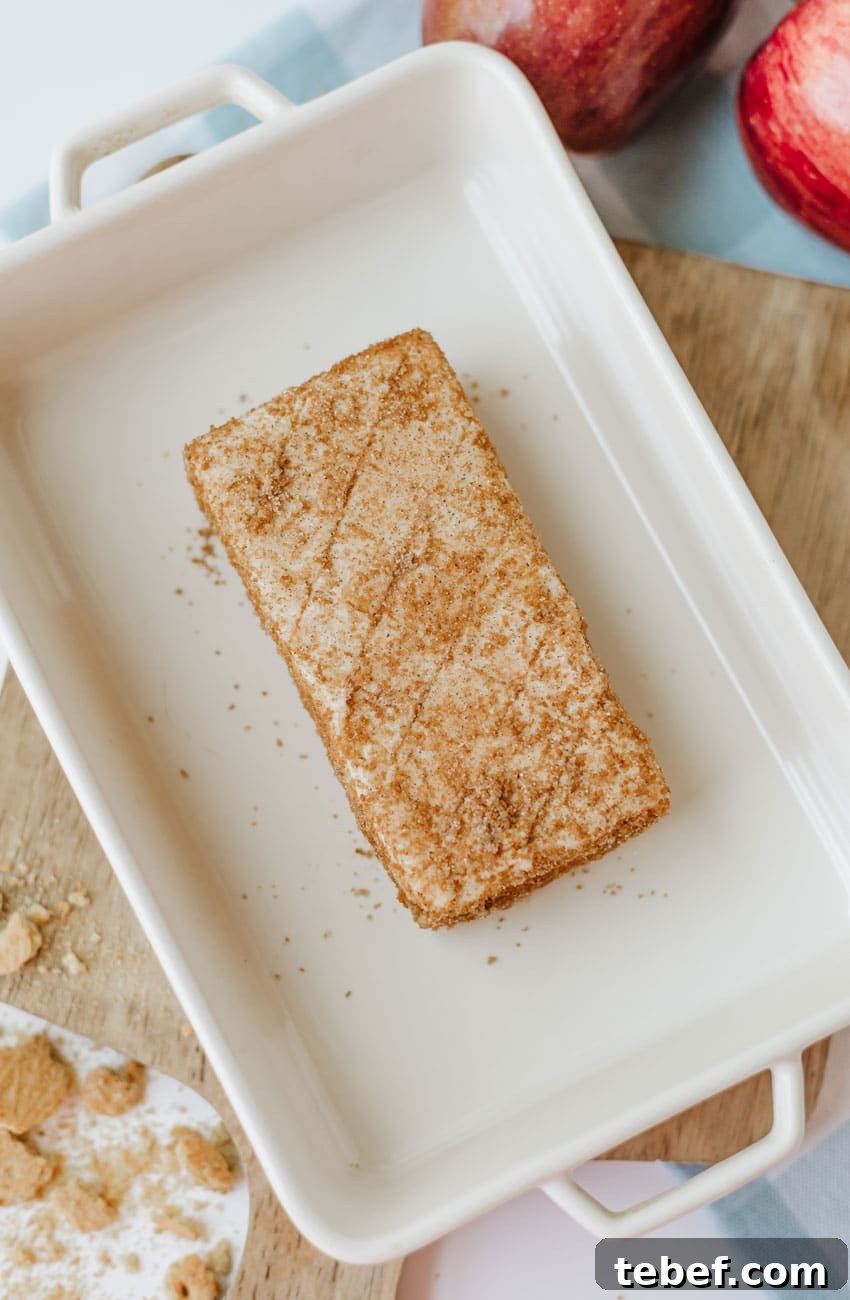 Smoked Cream Cheese with Apple Pie Flavor: Recipe & Tips 6 a cinnamon spice coated brick of cream cheese in a white baking dish