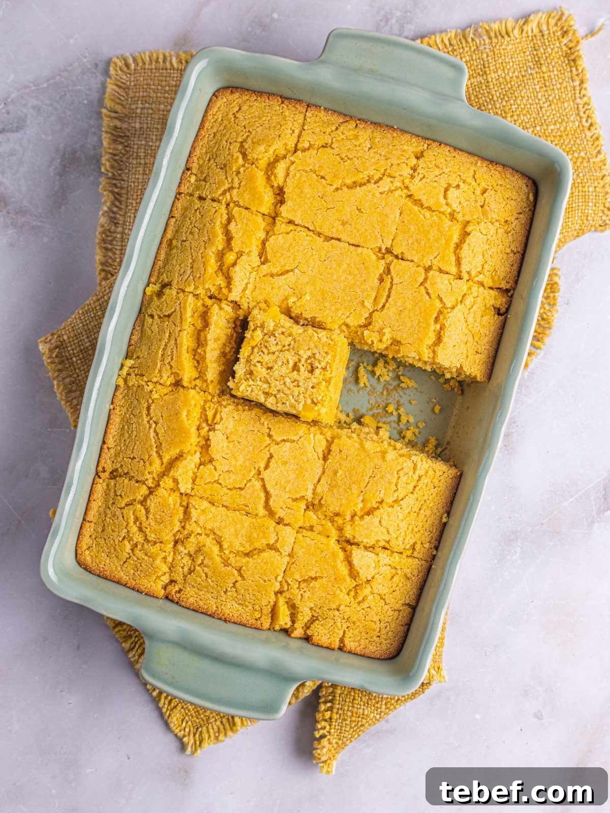 Moist Eggless Cornbread Recipe Without Eggs 4 Cornbread cut into squares in a baking dish and ready to be served.