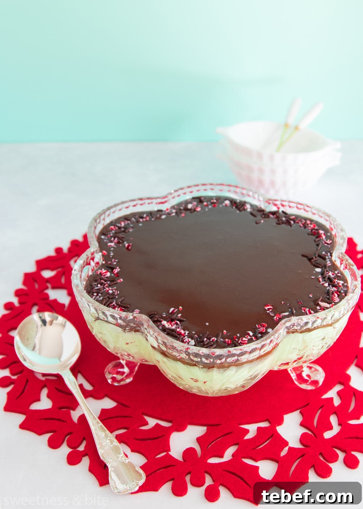 Creamy Peppermint Mousse Recipe for Festive Desserts 8 Mint mousse in a flower shaped cut glass bowl, topped with dark chocolate ganache and crushed candy canes.