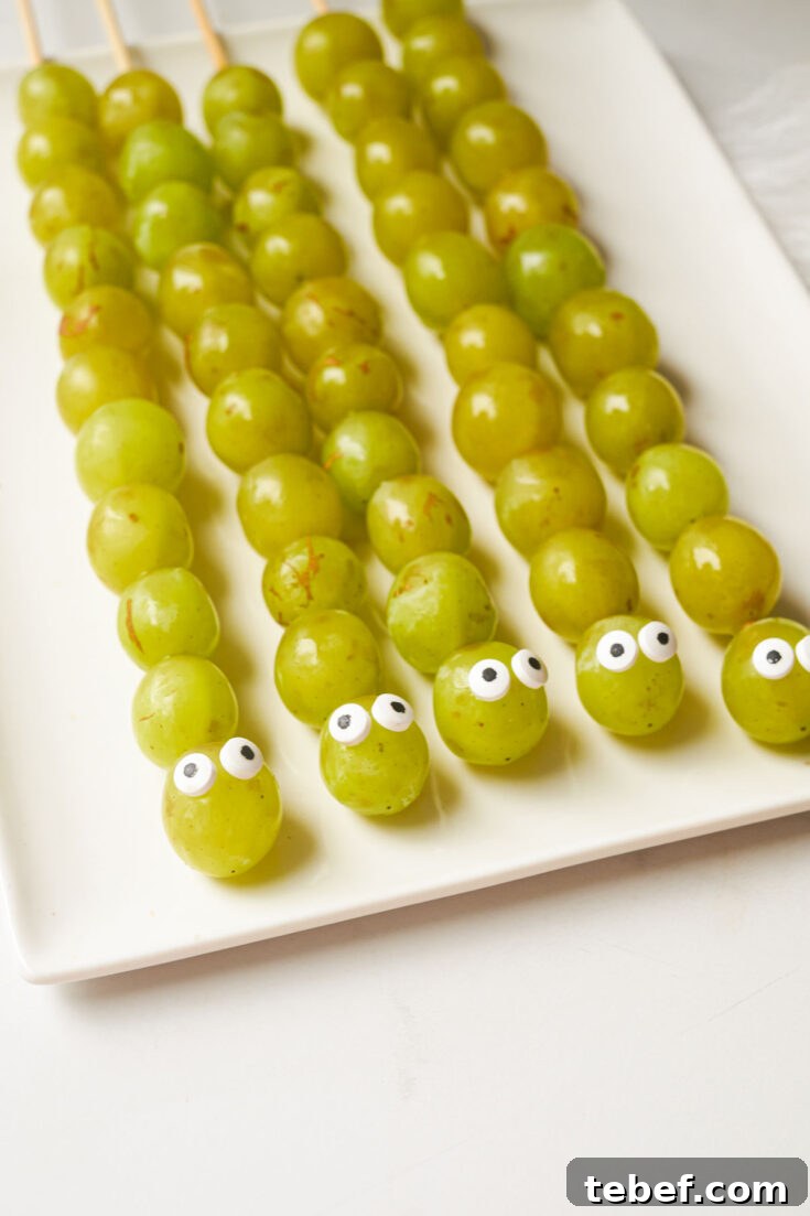 5 caterpillars on white plate.