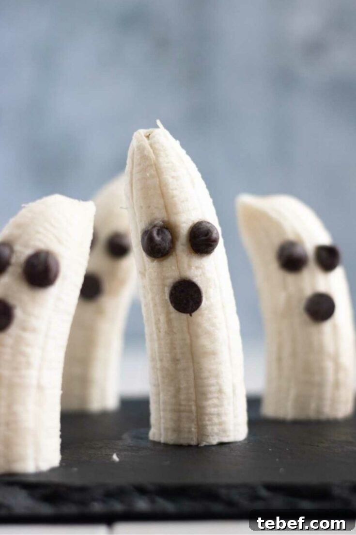 4 ghost bananas placed upright on black slate surface.