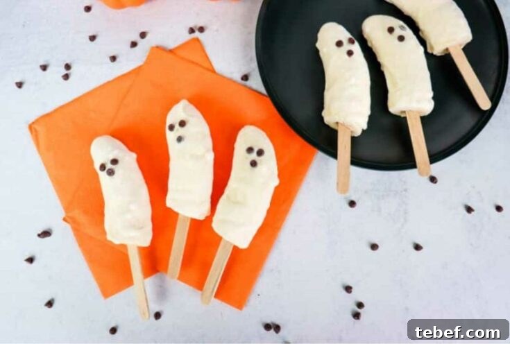 3 banana ghosts on orange napkins and three more on a black plate, with mini chocolate chips scattered around.