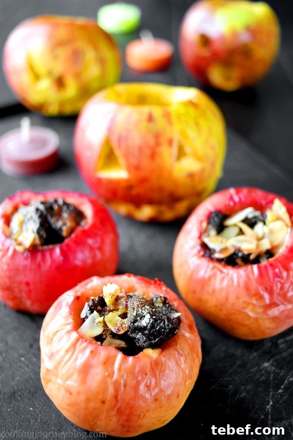 Three stuffed apples in front, with others carved like pumpkins behind.
