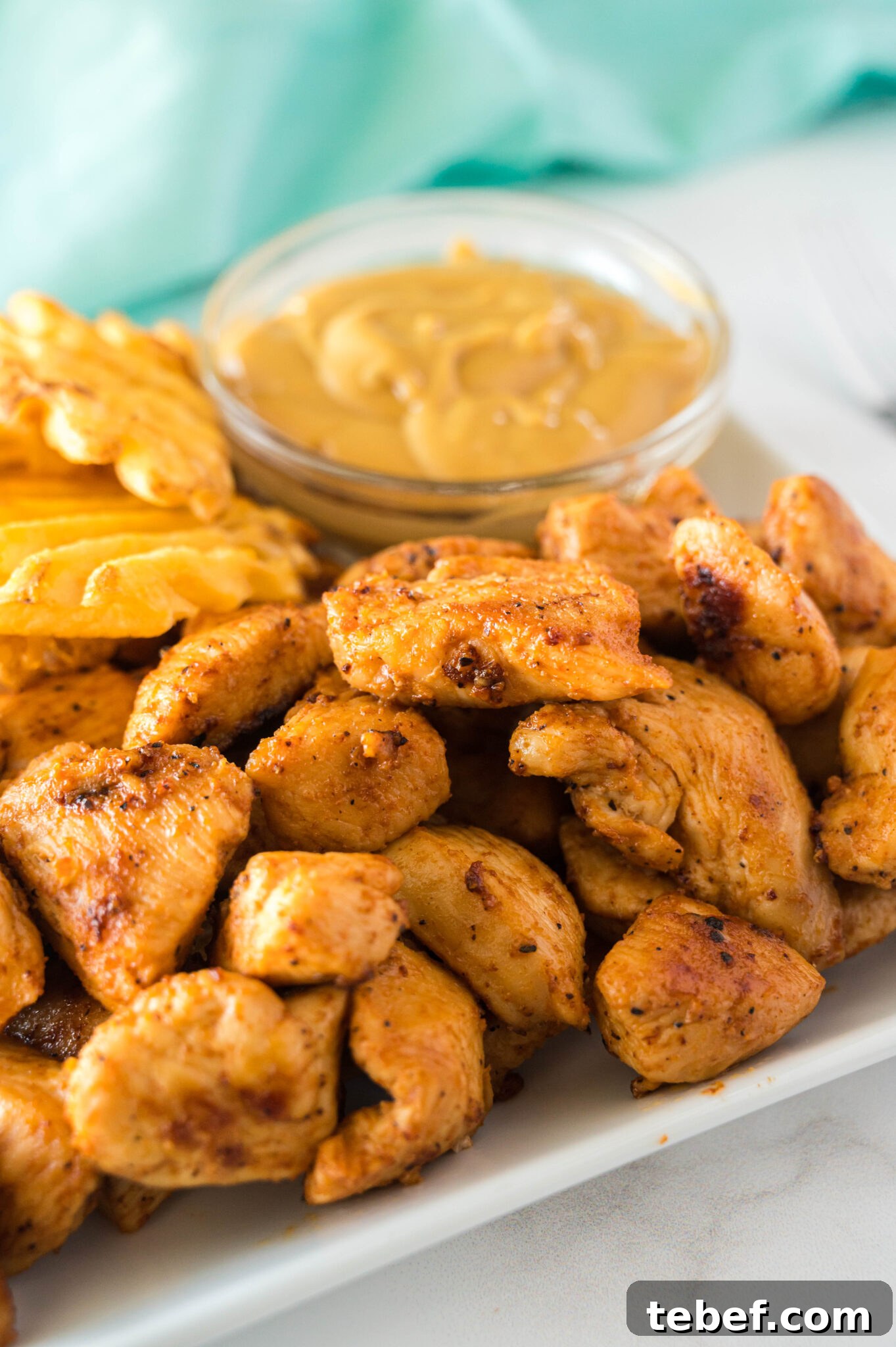 Copycat Chick-fil-A Grilled Nuggets Recipe: How to Make Them at Home 2 chick-fil-a grilled nuggets on a plate with chickfila sauce