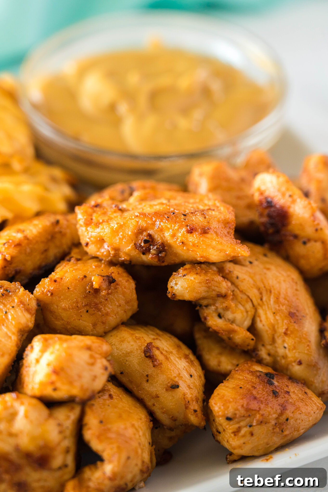 Copycat Chick-fil-A Grilled Nuggets Recipe: How to Make Them at Home 3 Copycat Chick-Fil-A grilled nuggets on a plate with a sauce and fries