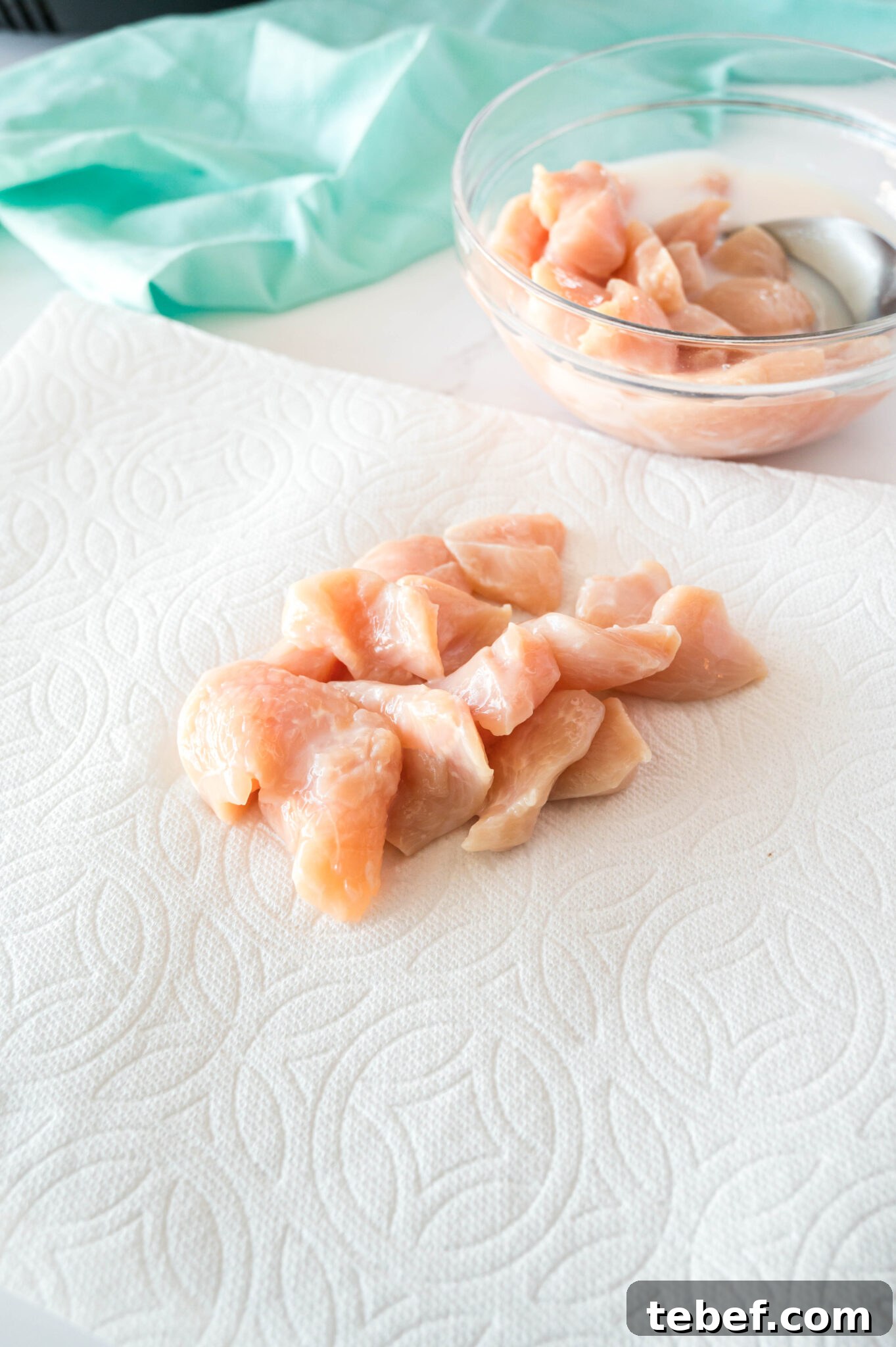 Copycat Chick-fil-A Grilled Nuggets Recipe: How to Make Them at Home 7 raw chicken pieces on a paper towel