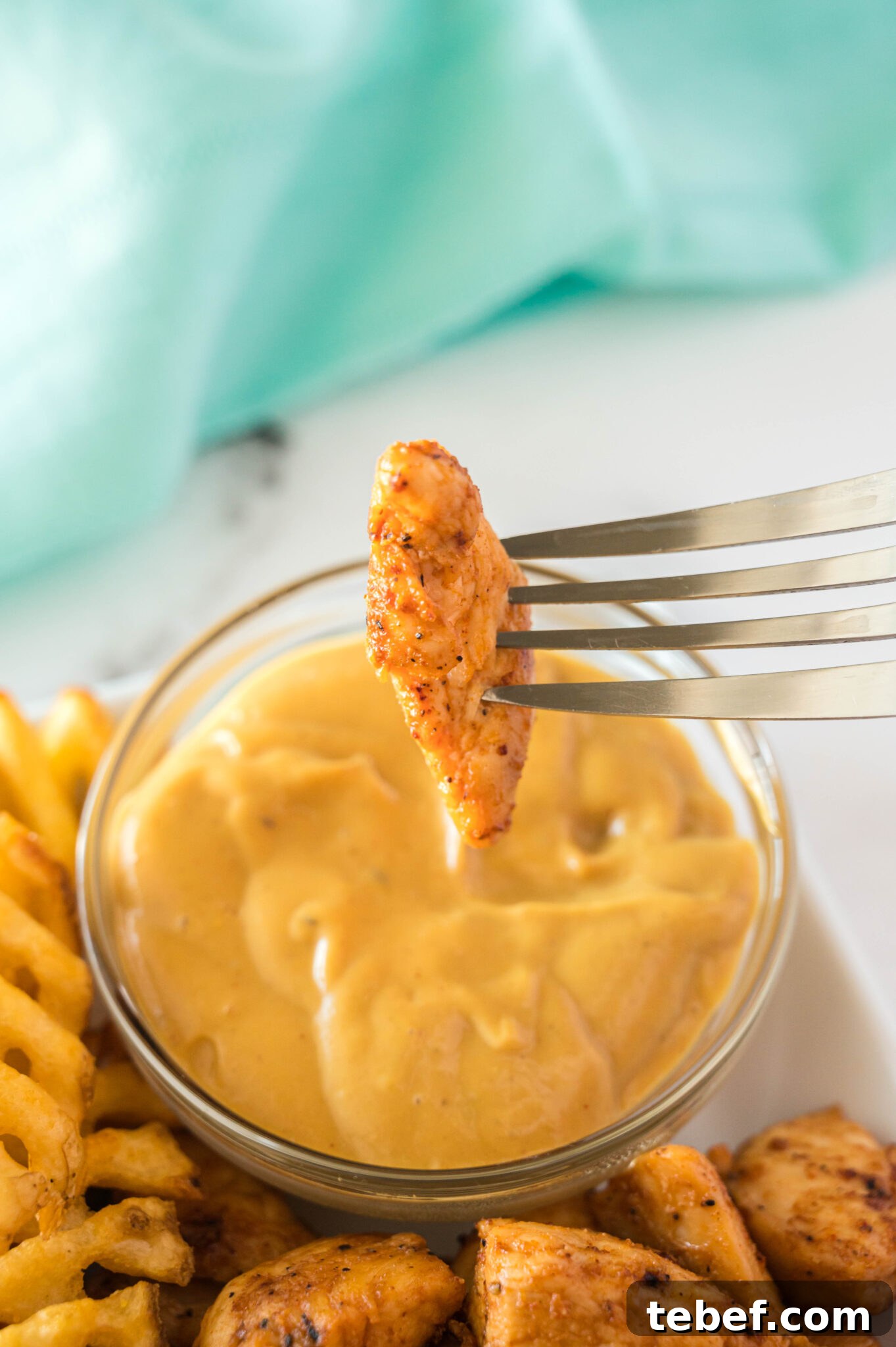 Copycat Chick-fil-A Grilled Nuggets Recipe: How to Make Them at Home 9 grilled nugget piece on a fork