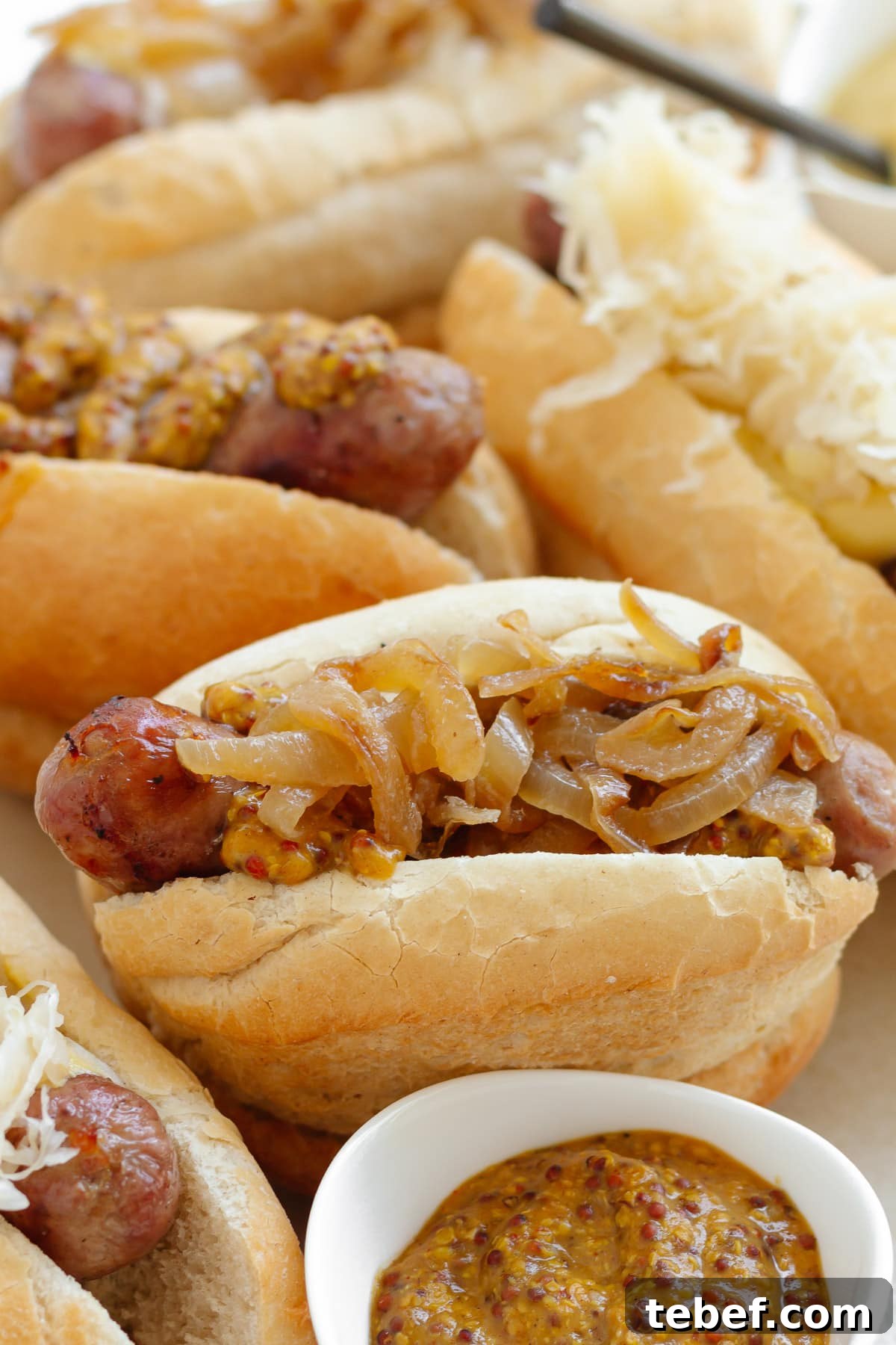 Grilled Bratwurst: Two Proven Methods for Perfect Brats 12 Grilled brats on buns with various toppings like mustard, beer braised onions and sauerkraut.
