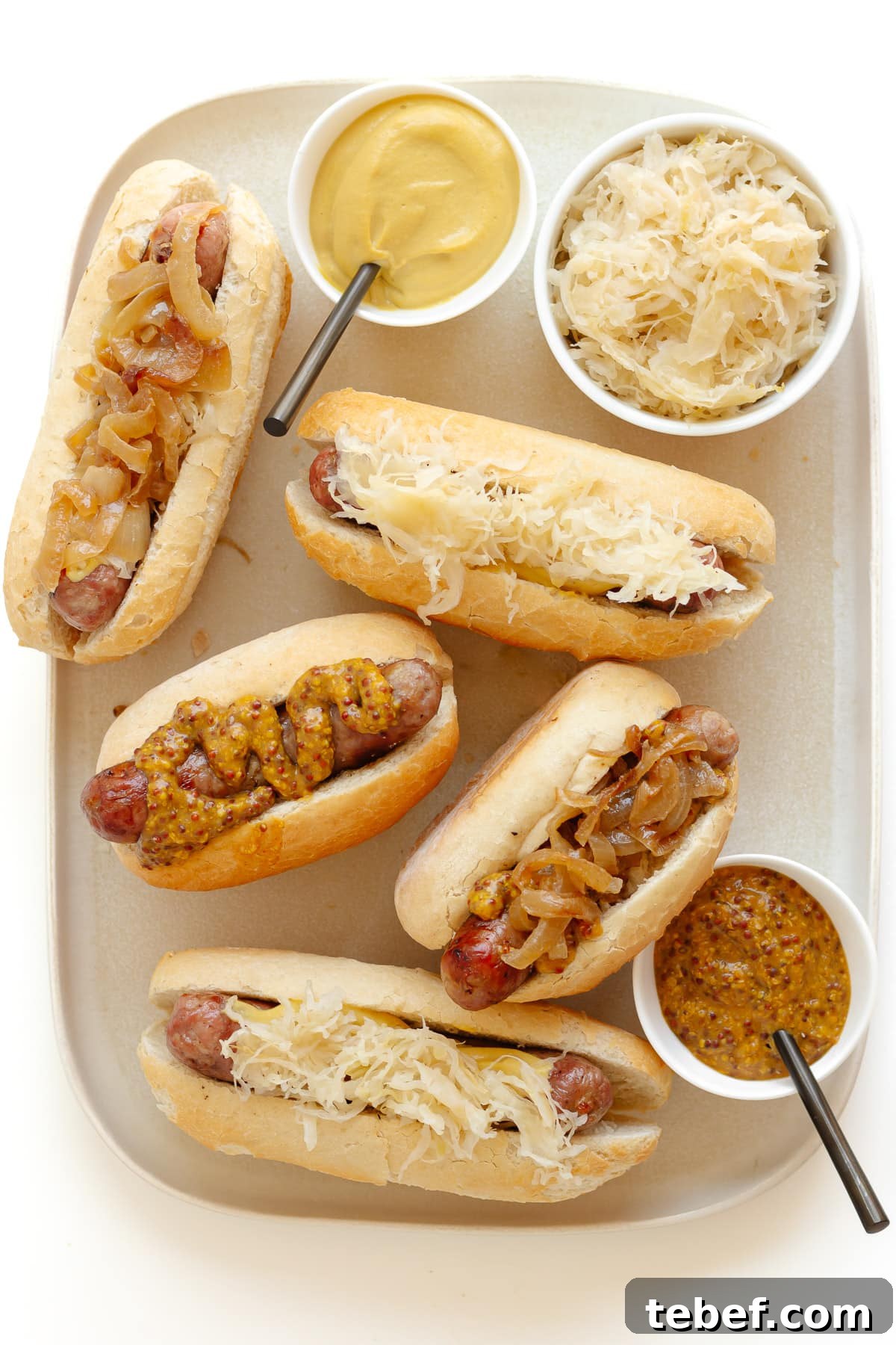 Grilled Bratwurst: Two Proven Methods for Perfect Brats 10 Platter of bratwurst in buns with various toppings.