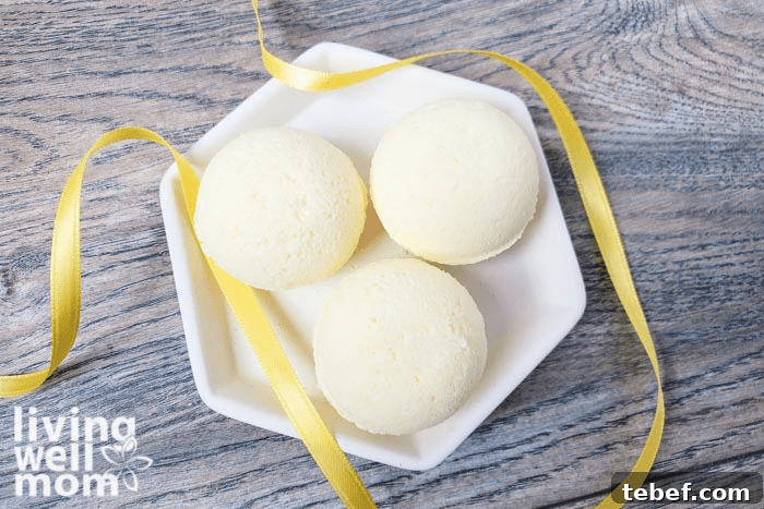 DIY Ultra-Hydrating Coconut Bath Bombs for Silky Skin 5 A tray of bath bombs with a yellow ribbon surrounding them.