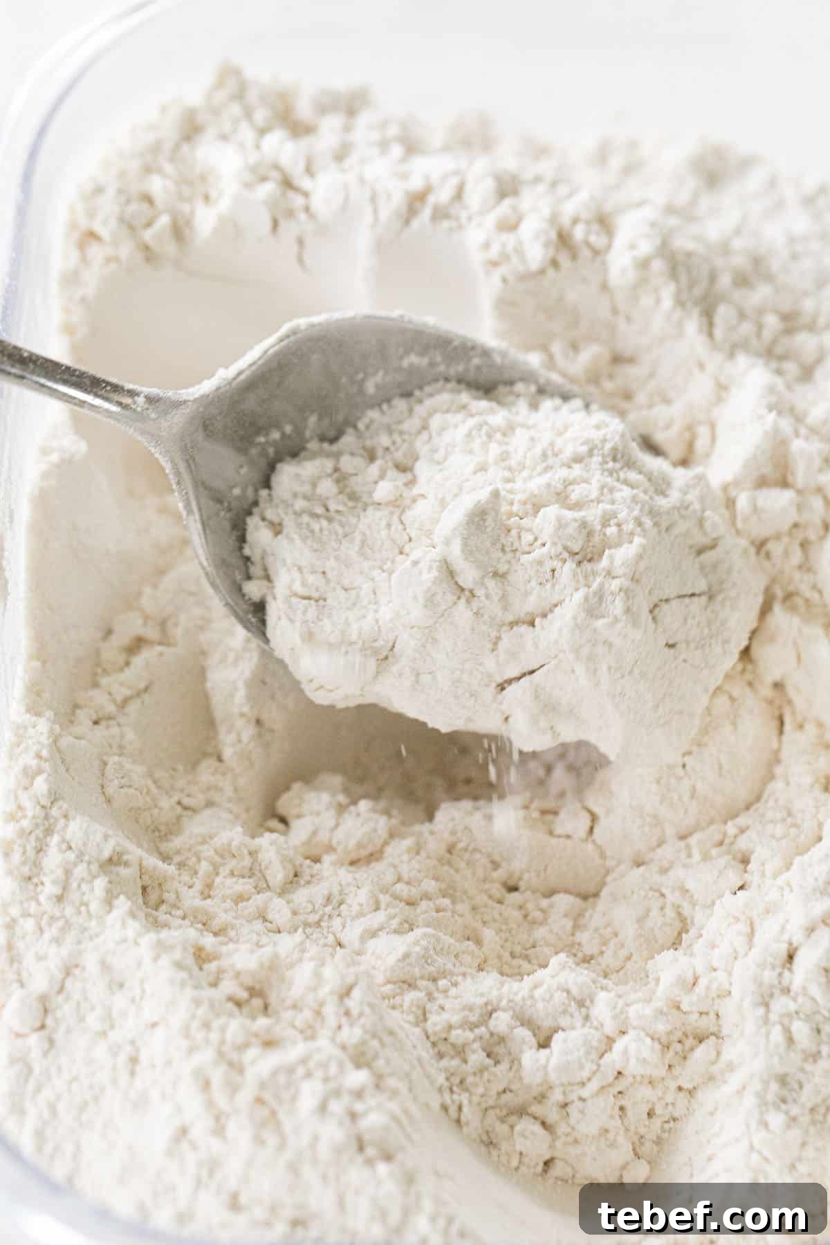 fluffing flour with a spoon