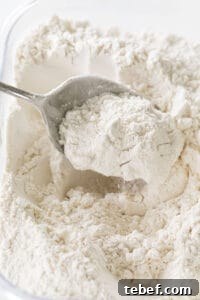 fluffing flour with a spoon