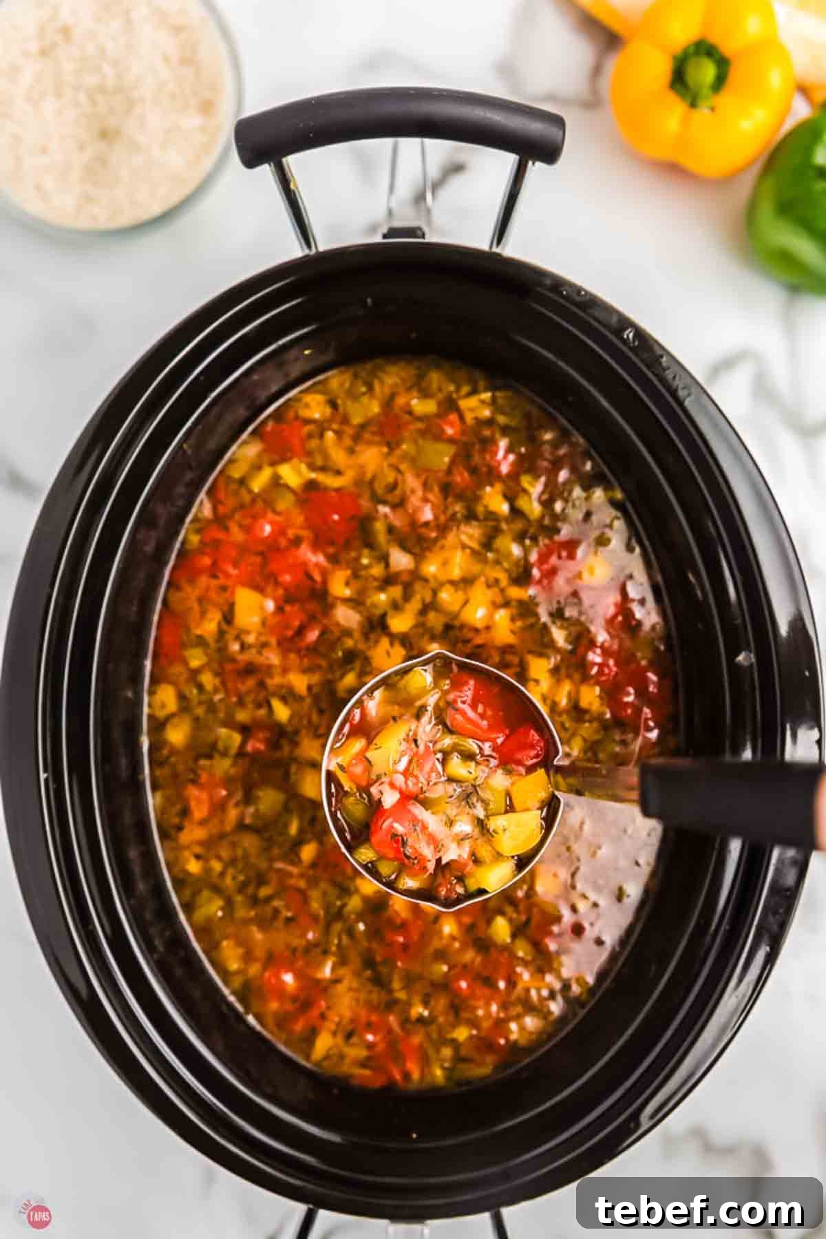 Slow Cooker Stuffed Pepper Soup Recipe for Comforting Weeknights 7 Pot of soup with a ladle scooping some out