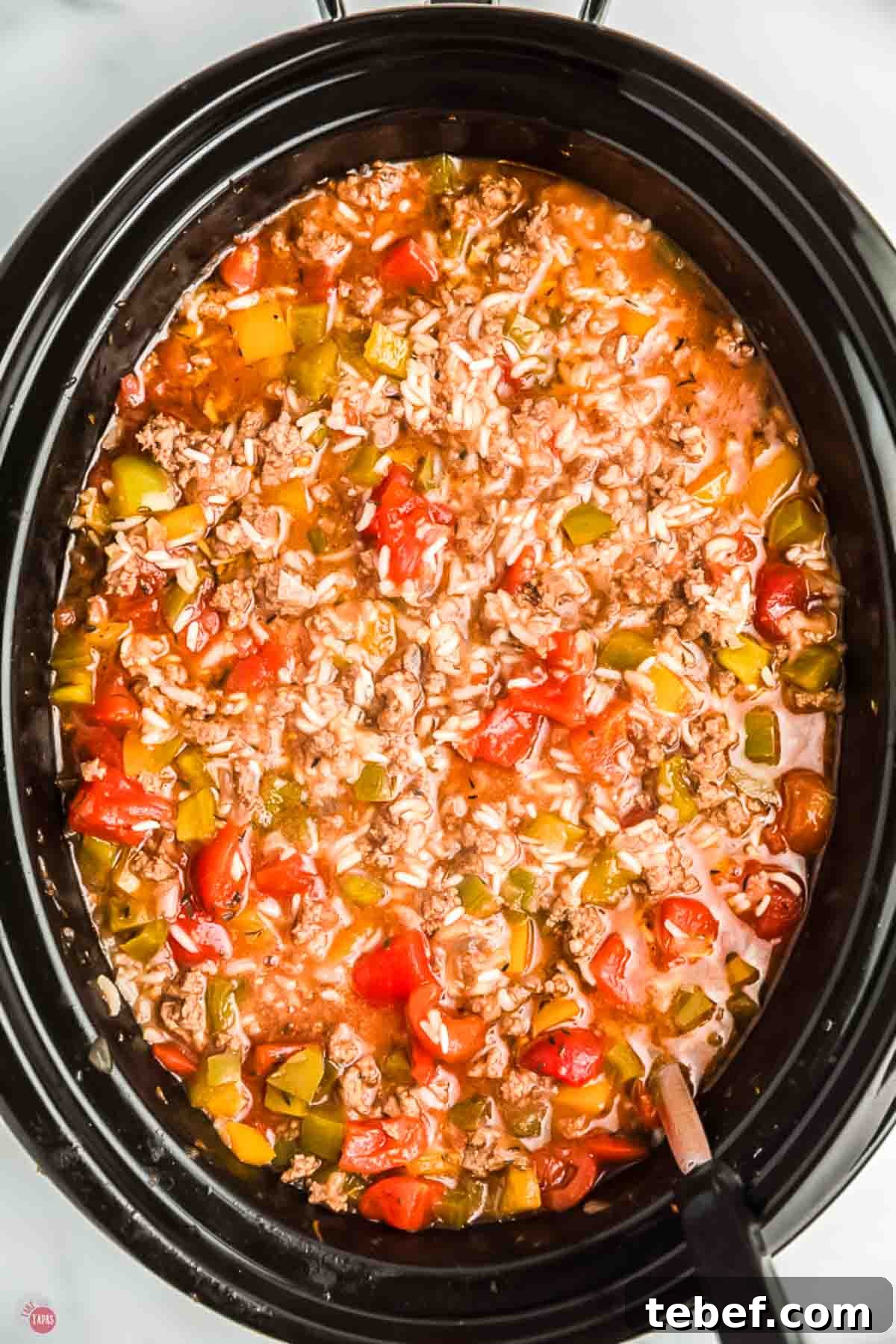 Slow Cooker Stuffed Pepper Soup Recipe for Comforting Weeknights 8 close up of black slow cooker with bell pepper soup in it