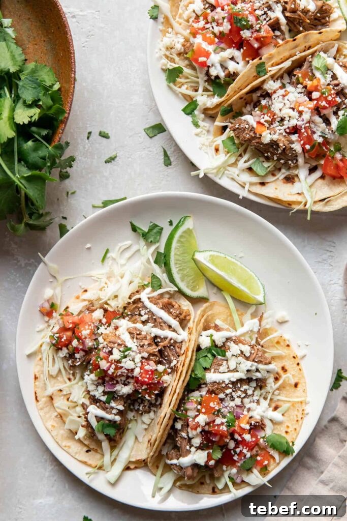 instant pot beef barbacoa tacos on a plate.
