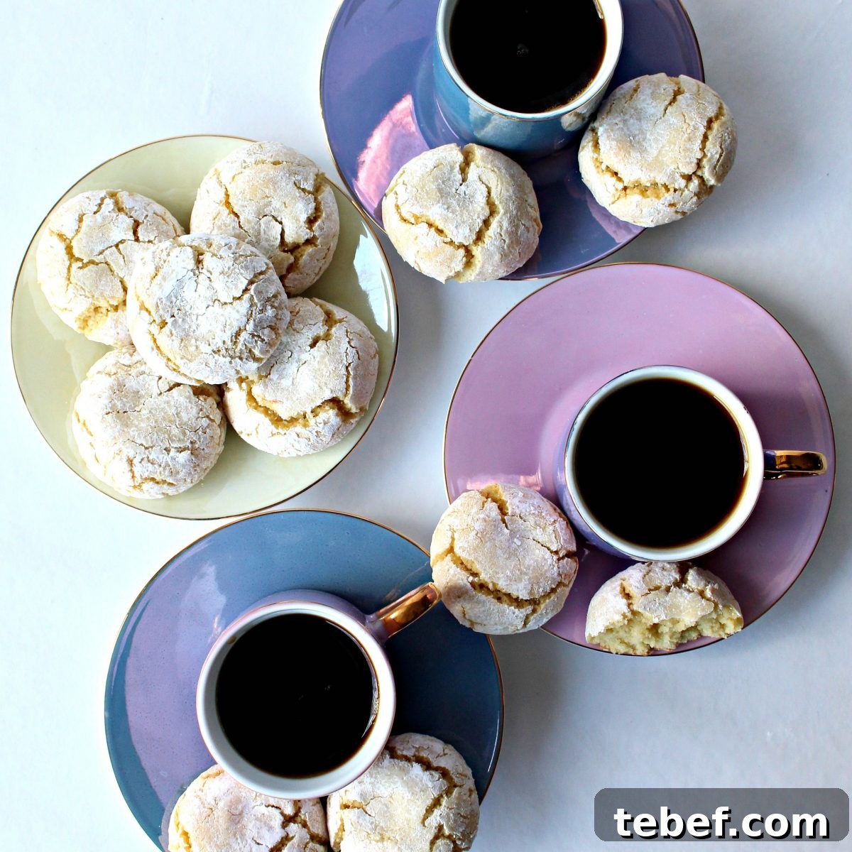 Assorted almond cookies and coffee. Cookies and coffee cups from above.