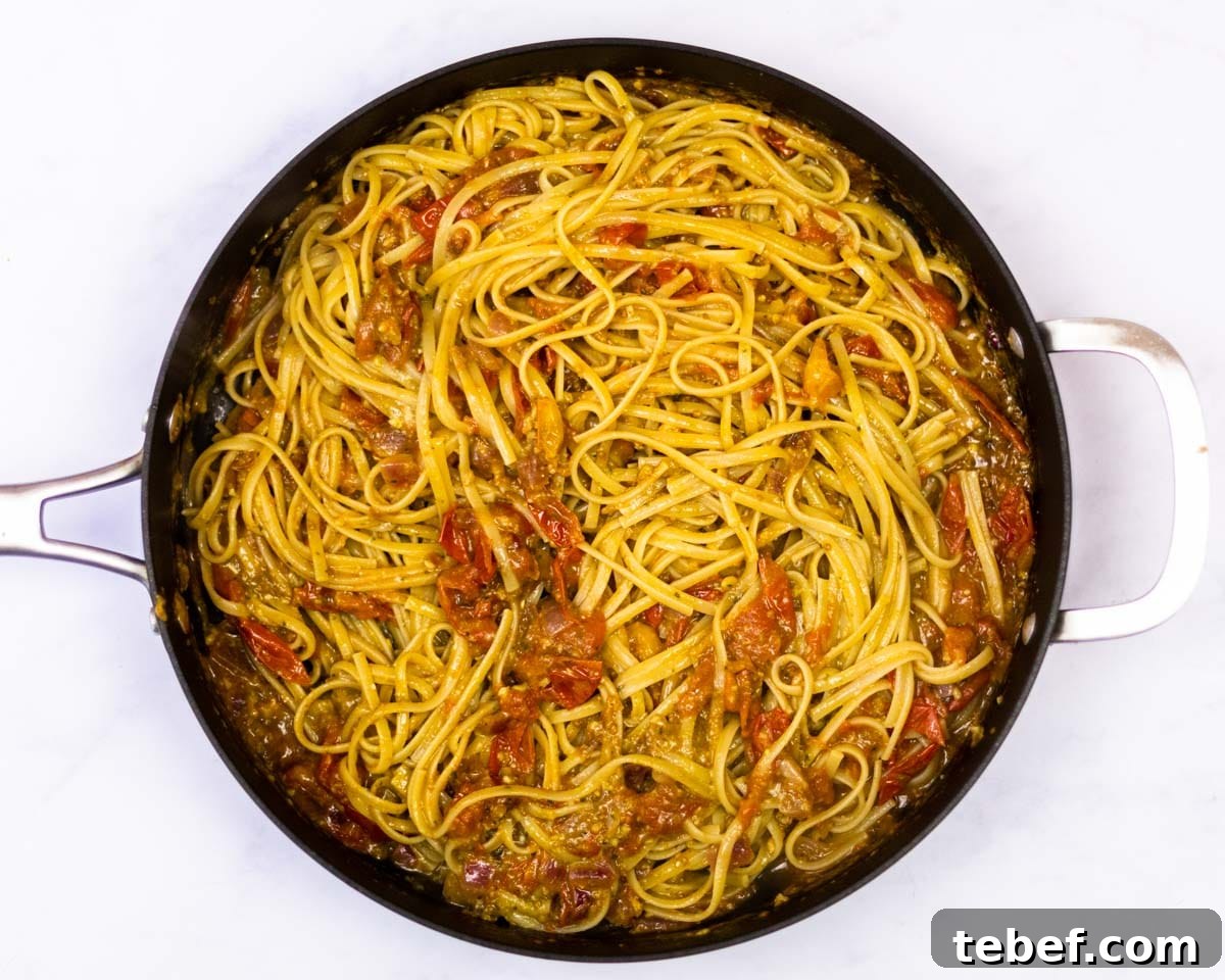 Cherry Tomato and Pesto Pasta Recipe for Quick Weeknight Meals 6 cherrry tomato pesto pasta in a saute pan.