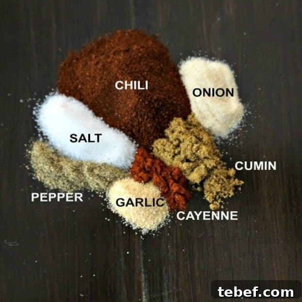 Copycat Chili Seasoning Chili seasoning spices labeled on wooden board.
