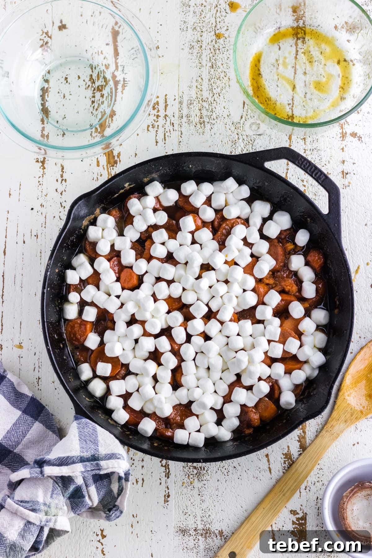 Southern Candied Yams Recipe with Brown Sugar and Pecans 7 Marshmallows added to the top of the sweet potatoes.