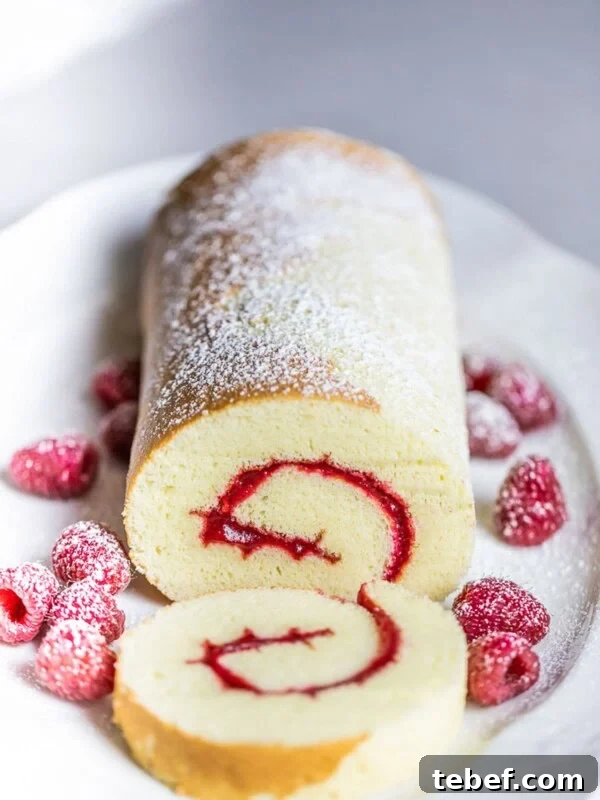 Authentic Japanese Strawberry Shortcake Recipe — Light, Fluffy Layers 14 swiss roll cake with raspberries on white plate