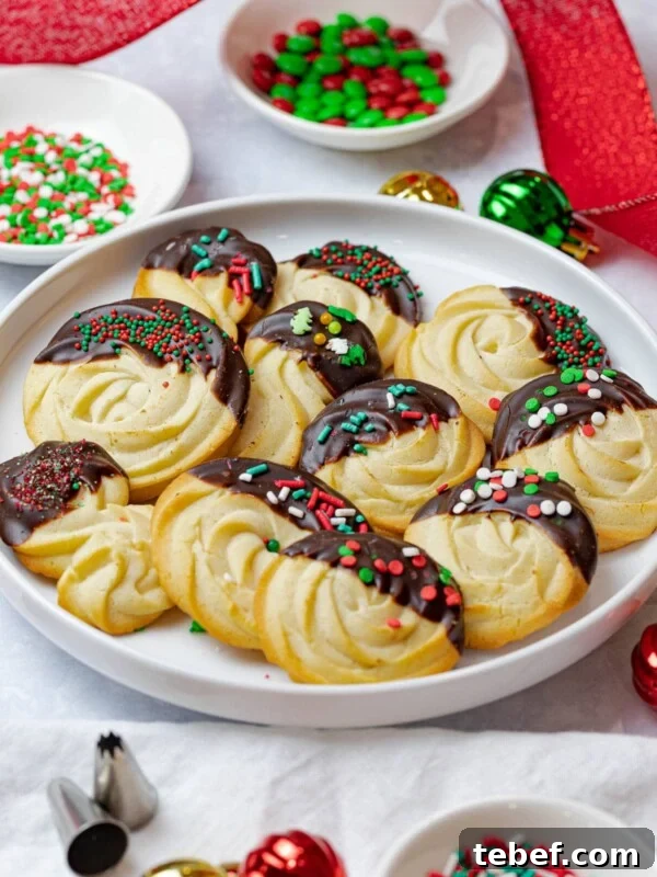 Authentic Japanese Strawberry Shortcake Recipe — Light, Fluffy Layers 16 Christmas butter cookies dipped in chocolate and decorated with sprinkles surrounded by holiday decorations and red ribbon